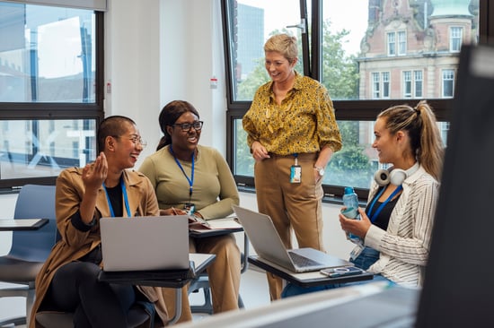 4 teachers having conversation and laughing 4 teachers having conversation and laughing